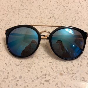 Sunglasses with blue tint on lens.